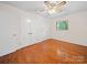 Bedroom features hardwood flooring, a ceiling fan, and closet space at 1261 Westbrook Cir, Gastonia, NC 28052