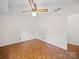 Bedroom with parquet floors, ceiling fan, neutral walls, and a doorway at 1261 Westbrook Cir, Gastonia, NC 28052