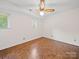 Bright bedroom with parquet floors, two windows, and a ceiling fan at 1261 Westbrook Cir, Gastonia, NC 28052