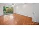 Bright bedroom with hardwood floors, ceiling fan, and sliding door to a private outdoor deck at 1261 Westbrook Cir, Gastonia, NC 28052