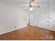 Bedroom features parquet flooring, a ceiling fan, and closet space at 1261 Westbrook Cir, Gastonia, NC 28052