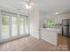 Bright breakfast nook featuring tile flooring, multiple windows, and a pass-through to the kitchen at 1261 Westbrook Cir, Gastonia, NC 28052