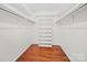 Walk-in closet features hardwood floors, shelving, and hanging racks at 1261 Westbrook Cir, Gastonia, NC 28052