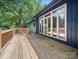 A lovely wooden deck offering outdoor space and a wall of windows providing ample natural light inside the house at 1261 Westbrook Cir, Gastonia, NC 28052