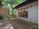 Charming wooden deck featuring a sliding glass door and scenic backyard views at 1261 Westbrook Cir, Gastonia, NC 28052