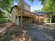 Exterior view showcasing a multi-level deck system, outdoor patio, and lush backyard space at 1261 Westbrook Cir, Gastonia, NC 28052