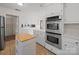 Modern kitchen features stainless steel appliances, white cabinetry, and tile flooring at 1261 Westbrook Cir, Gastonia, NC 28052