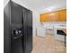 Laundry room featuring a refrigerator, washing machine, dryer, sink, and cabinets at 1261 Westbrook Cir, Gastonia, NC 28052