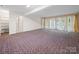 Spacious living room features unique carpet design and plenty of natural light at 1261 Westbrook Cir, Gastonia, NC 28052