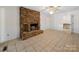 Living room with a stone fireplace and tiled floors at 1261 Westbrook Cir, Gastonia, NC 28052