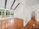 Bright living room boasts vaulted ceilings with wood beams, hardwood floors, and access to a deck at 1261 Westbrook Cir, Gastonia, NC 28052