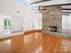 Spacious living room boasts a prominent stone fireplace and gleaming hardwood floors at 1261 Westbrook Cir, Gastonia, NC 28052