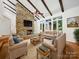 Inviting living room featuring hardwood floors, a stone fireplace, and ample seating at 1261 Westbrook Cir, Gastonia, NC 28052