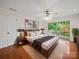 Spacious main bedroom features hardwood floors, a ceiling fan, and a sliding door to a private deck at 1261 Westbrook Cir, Gastonia, NC 28052