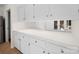 Bright pantry features white cabinetry and countertops, with convenient access to outdoors at 1261 Westbrook Cir, Gastonia, NC 28052