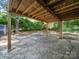 View of a covered patio area under a raised deck, offering space for outdoor activities and relaxation at 1261 Westbrook Cir, Gastonia, NC 28052
