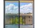 Relax on this balcony overlooking a lush cityscape under a bright, cloud-filled sky at 1315 East Blvd # 611, Charlotte, NC 28203