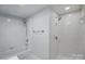 Bathroom with shower and tub combination featuring elegant fixtures and bright white tile at 1315 East Blvd # 611, Charlotte, NC 28203