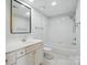 Bright bathroom featuring a single sink vanity and tub with shower and clean white tile at 1315 East Blvd # 611, Charlotte, NC 28203