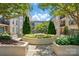 A tranquil courtyard view with trees, flowers, and building balconies above at 1315 East Blvd # 611, Charlotte, NC 28203