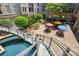 Stairway descends to the courtyard, featuring trees, benches, and colorful sun umbrellas at 1315 East Blvd # 611, Charlotte, NC 28203