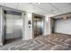 Hallway with carpet, recessed lights, wall mounted lights, and two stainless steel elevators at 1315 East Blvd # 611, Charlotte, NC 28203