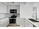 Bright kitchen featuring white cabinets, stainless steel appliances and a modern sink with chrome faucet at 1315 East Blvd # 611, Charlotte, NC 28203