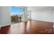 Bright living area with wood floors, large windows, and a balcony providing ample natural light and views at 1315 East Blvd # 611, Charlotte, NC 28203