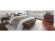 Cozy main bedroom featuring hardwood floors, neutral tones, and ample natural light from balcony access at 1315 East Blvd # 611, Charlotte, NC 28203