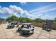 Rooftop deck with picnic tables offers a scenic view of clear blue skies and lush green trees at 1315 East Blvd # 611, Charlotte, NC 28203