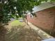 Spacious backyard featuring a fenced perimeter, a storage shed and brick home at 13427 Homewood Dr, Charlotte, NC 28262