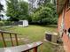 A spacious backyard featuring a well-maintained lawn, storage shed, and central air unit at 13427 Homewood Dr, Charlotte, NC 28262