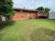 Large backyard with brick home, deck, outbuilding and central air unit at 13427 Homewood Dr, Charlotte, NC 28262