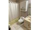 A simple bathroom features a standard tub with shower, white toilet, and a cabinet above toilet at 13427 Homewood Dr, Charlotte, NC 28262