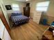 Bedroom featuring a bed with patterned bedding, a dresser, and a window for natural light at 13427 Homewood Dr, Charlotte, NC 28262