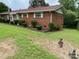 Quaint brick home showcasing mature landscaping, adding natural beauty at 13427 Homewood Dr, Charlotte, NC 28262