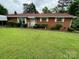 Traditional brick home featuring well-manicured landscaping, offering curb appeal at 13427 Homewood Dr, Charlotte, NC 28262