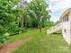 Beautifully maintained backyard with ample green space, complemented by lush trees and a charming staircase at 138 Shepherd Rd, Mooresville, NC 28115