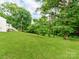 Expansive backyard featuring lush green grass and mature trees creating a serene, private outdoor space at 138 Shepherd Rd, Mooresville, NC 28115