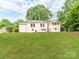 Backyard featuring a lush green lawn and a home exterior with charming wooden staircase at 138 Shepherd Rd, Mooresville, NC 28115