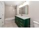 Bathroom with a stylish green vanity, a shower and a rectangular mirror with plenty of lighting at 138 Shepherd Rd, Mooresville, NC 28115