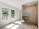 Bright bathroom with glass shower, stone base and natural light streaming in through two large windows at 138 Shepherd Rd, Mooresville, NC 28115