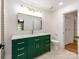 Bathroom with a stylish green vanity, a rectangular mirror and plenty of lighting at 138 Shepherd Rd, Mooresville, NC 28115