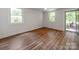 Spacious bedroom with hardwood floors, white walls, and three points of egress: A door and two windows at 138 Shepherd Rd, Mooresville, NC 28115