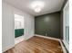 Bedroom with wood flooring and an en suite bathroom featuring a green vanity and gold hardware at 138 Shepherd Rd, Mooresville, NC 28115