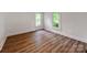 A bright bedroom featuring beautiful wood floors and two windows allowing for plenty of natural light at 138 Shepherd Rd, Mooresville, NC 28115