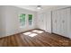 Sunny bedroom with hardwood floors, double closets, and natural light from large windows at 138 Shepherd Rd, Mooresville, NC 28115
