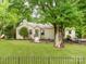 Charming single-story home with a well-manicured lawn and beautiful landscaping with a walkway leading to the front door at 138 Shepherd Rd, Mooresville, NC 28115