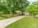 Beautifully landscaped home with a long driveway and fenced yard at 138 Shepherd Rd, Mooresville, NC 28115
