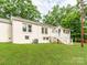 Rear exterior view of a bright home, showcasing a well-maintained yard and multiple windows at 138 Shepherd Rd, Mooresville, NC 28115